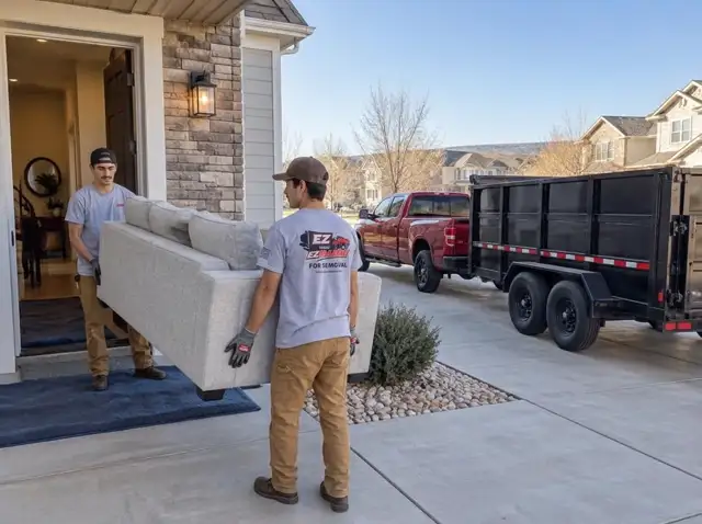 Furniture removal in Parker, CO — couch and living room furniture loaded into the EZ Haulaway dump trailer