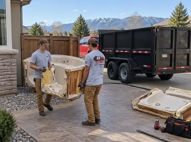 Hot tub removal in Parker, CO — EZ Haulaway crew cutting out and hauling away a backyard spa