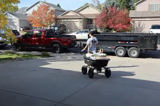 Residential junk removal in Parker, CO — garage cleanout with household junk loaded into the dump trailer